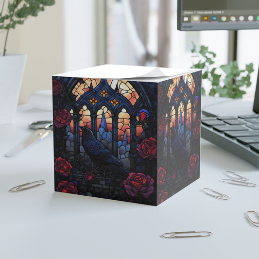 Decorative note cube with stained glass design and roses on a desk