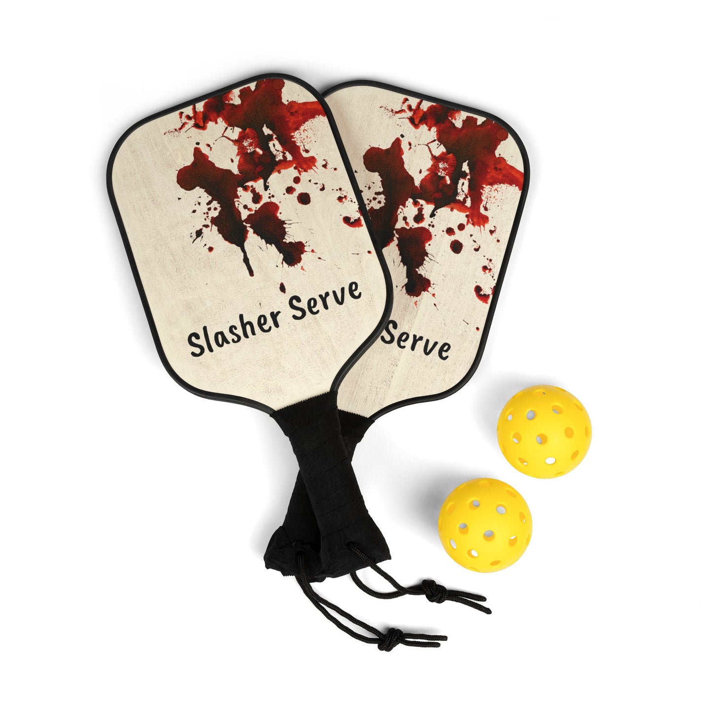 Pickleball paddles with 'Slasher Serve' text and blood splatter design, accompanied by two yellow pickleballs on a white background.